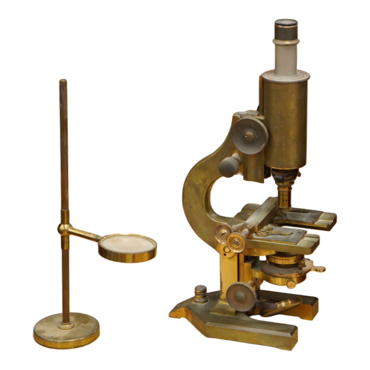An early 20th century brass compound monocular microscope, by R & J Beck, Ltd., London, number 33007, with accessories including spare lenses, a free standing magnifier and objectives, mahogany cased; 34.5cm high, 19cm w